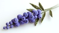 Delicate paper quilled lavender flower stem with purple rolled coils and green leaves, handcrafted botanical art piece on white background.