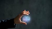 Business professional hands protecting glowing AI artificial intelligence icon symbol representing technology innovation and digital transformation concepts.