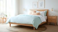 Modern bedroom interior with wooden bed frame, mint green polka dot bedding, white walls, natural light, and minimalist wall art. Cozy Scandinavian style decor.