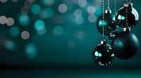 Elegant turquoise Christmas ornaments hanging against dark background with bokeh lights creating festive holiday atmosphere. Modern color scheme for seasonal decor.