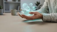 Businessman holding holographic cloud computing icons above hands in modern office workspace representing digital transformation and data storage technology.