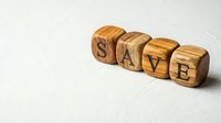 Wooden letter blocks spelling SAVE on white background for financial planning and money management concepts.