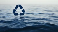 Recycling symbol floating on ocean water surface with gentle waves, highlighting environmental conservation and marine pollution awareness.