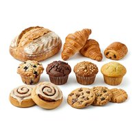 Assorted fresh baked goods including artisan bread, croissants, muffins, pastries and cookies isolated on white background for bakery, cafe and food service design projects.