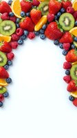 Fresh mixed berries and fruits arranged in heart shape on white background with copy space for healthy eating and nutrition concepts.