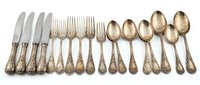 Antique silver flatware set with ornate engraved handles, including knives, forks, and spoons arranged on white background, elegant tableware collection.