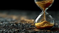 Hourglass with golden sand flowing through glass bulbs on textured dark surface symbolizing time passage, deadlines, and life concepts for business presentations.