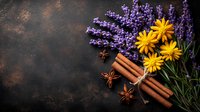 Fresh lavender sprigs with bright yellow daisies, aromatic cinnamon sticks and star anise on dark rustic background, natural aromatherapy and spa concept.