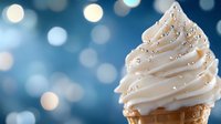 Soft serve vanilla ice cream cone with silver sprinkles against blurred blue bokeh background, creamy swirled texture and festive sparkle for dessert advertising.