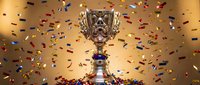 Golden trophy cup with ornate design surrounded by colorful confetti falling against warm background for victory celebration and achievement recognition.