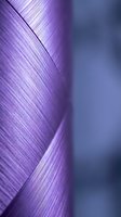 Abstract purple and blue flowing curves with smooth gradient transitions and soft lighting effects for modern digital design backgrounds.