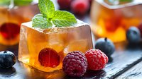Refreshing iced tea cocktail with fresh berries and mint garnish on rustic wooden table. Summer beverage concept for restaurants and cafes.