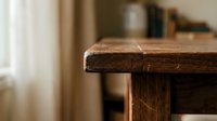 Rustic wooden table corner showcasing natural wood grain texture and craftsmanship in warm home interior setting for furniture and decor projects.