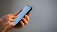 Hands holding modern smartphone with blank screen for mobile app mockup and digital communication technology concepts.