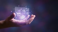 Businessman hand holding glowing holographic KPI dashboard with charts and analytics icons for business performance measurement and data analysis.