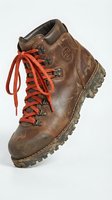 Worn brown leather hiking boot with red laces and rugged sole, isolated on white background. Suitable for outdoor adventure, travel, and footwear design projects.