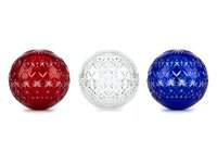 Festive ornamental spheres in red, white, and blue with star patterns, isolated on white background. Perfect for holiday designs, seasonal graphics, and festive decorations.