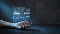 Businessman hand holding holographic display with financial charts and data analytics for digital business solutions.