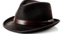 Classic brown felt fedora hat with leather band isolated on white background for fashion accessories and menswear design projects.