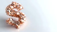 Elegant rose gold letter S decorated with sparkling crystals and intricate floral filigree pattern on white background, isolated jewelry design element.