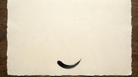 Minimalist black curved line on cream textured paper isolated on wooden surface, suitable for graphic design, branding, and creative projects.