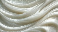 Creamy white frosting with smooth swirls and glossy texture, close-up view showing rich detail for bakery and dessert applications.