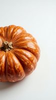 Fresh orange pumpkin with ribbed texture isolated on white background for autumn harvest decorations and seasonal cooking projects.