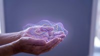 Glowing purple brain hologram floating above cupped hands representing artificial intelligence, neuroscience, mental health and cognitive technology concepts.