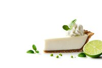 Creamy key lime pie slice with whipped cream topping, fresh lime halves, and mint leaves on white background, isolated dessert for menu and promotional materials.