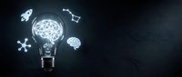 Glowing light bulb with brain inside surrounded by innovation icons on dark background representing creativity and business ideas.