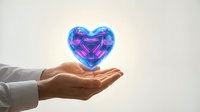 Glowing holographic heart floating above open palm symbolizing love, care and emotional connection in futuristic digital healthcare concept.