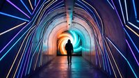 Silhouette of person walking through futuristic tunnel with colorful neon lights creating dynamic geometric patterns and glowing archway entrance.