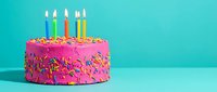 Colorful birthday cake with pink frosting, rainbow sprinkles, and lit candles on a bright turquoise background for celebration designs.