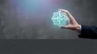 Hand holding glowing compass rose symbol against blurred background. Represents navigation, direction, guidance, and strategic planning for business concepts.