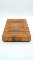 Wooden cutting board with end grain construction featuring mixed wood tones, isolated on white background, ready for kitchen and culinary design projects.