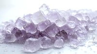 Delicate purple-tinted salt crystals in macro view create abstract mineral texture with soft light illumination. Natural crystalline formation shows transparent structure.