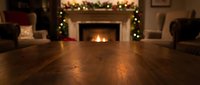 Cozy Christmas living room interior with fireplace and holiday decorations, warm wooden floor perspective for seasonal home design and festive atmosphere.