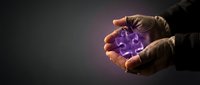 Hands holding glowing purple puzzle piece symbolizing problem solving and innovation in business strategy and teamwork concepts.