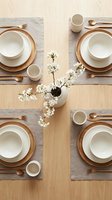 Elegant dining table setting with neutral tableware and white cherry blossom centerpiece for spring entertaining and home decor inspiration.