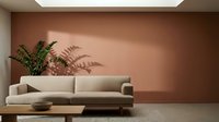 Modern beige sofa with green plants against terracotta wall in minimalist living room interior design space for home decor.