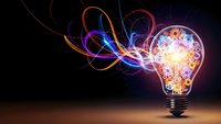 Glowing light bulb with colorful energy streams and gears inside representing innovation, creativity and bright ideas on dark background.
