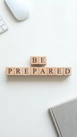 Be prepared text formed with wooden blocks on white desk with computer mouse and keyboard, motivational business concept for readiness and planning.