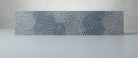 Gray textured ceramic tile with geometric diamond pattern for modern interior design and bathroom renovation projects.