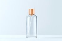 Clear glass cosmetic bottle with copper metallic cap on white background, minimalist luxury packaging design for beauty and skincare products.