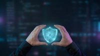 Hands holding glowing digital shield symbol representing cybersecurity, data protection, and network safety in modern technology environment for business security concepts.