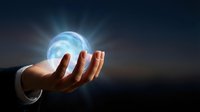 Businessman hand holding glowing blue energy sphere with light rays against dark background for technology and innovation concepts.