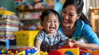 Asian mother and laughing toddler boy playing with colorful educational toys together at home, capturing genuine joy and developmental learning moment.