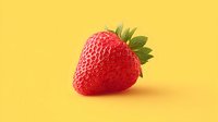 Fresh ripe red strawberry with green leaves on bright yellow background for healthy eating and summer fruit concepts.