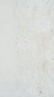 Weathered concrete wall with aged texture, dirt stains, and scratches. Neutral beige and white surface with natural wear patterns for backgrounds, overlays, or design elements.