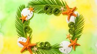 Tropical summer frame with palm leaves, starfish and sand dollars on watercolor background for vacation designs and beach themed projects.